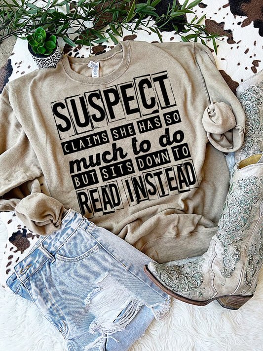 Suspect claims she has so much to do but sits down to read instead.