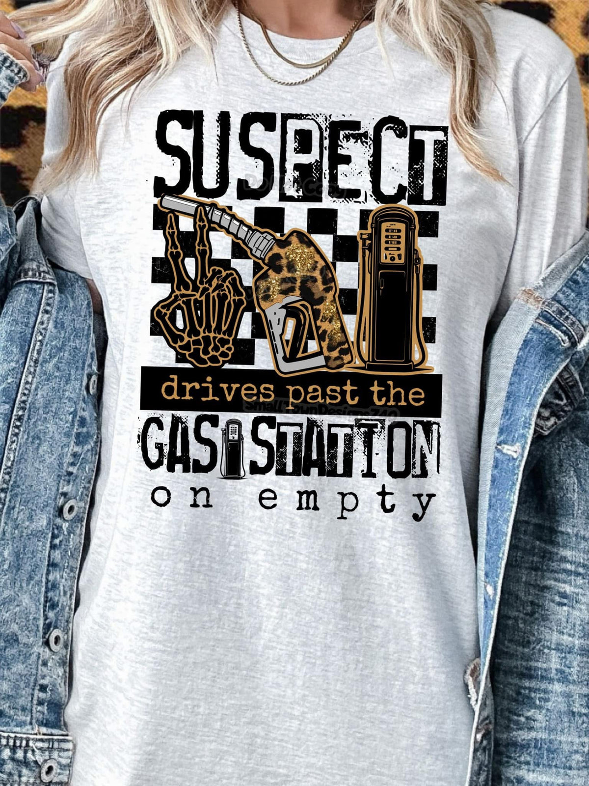 Suspect drives past the gas station on empty graphic shirt